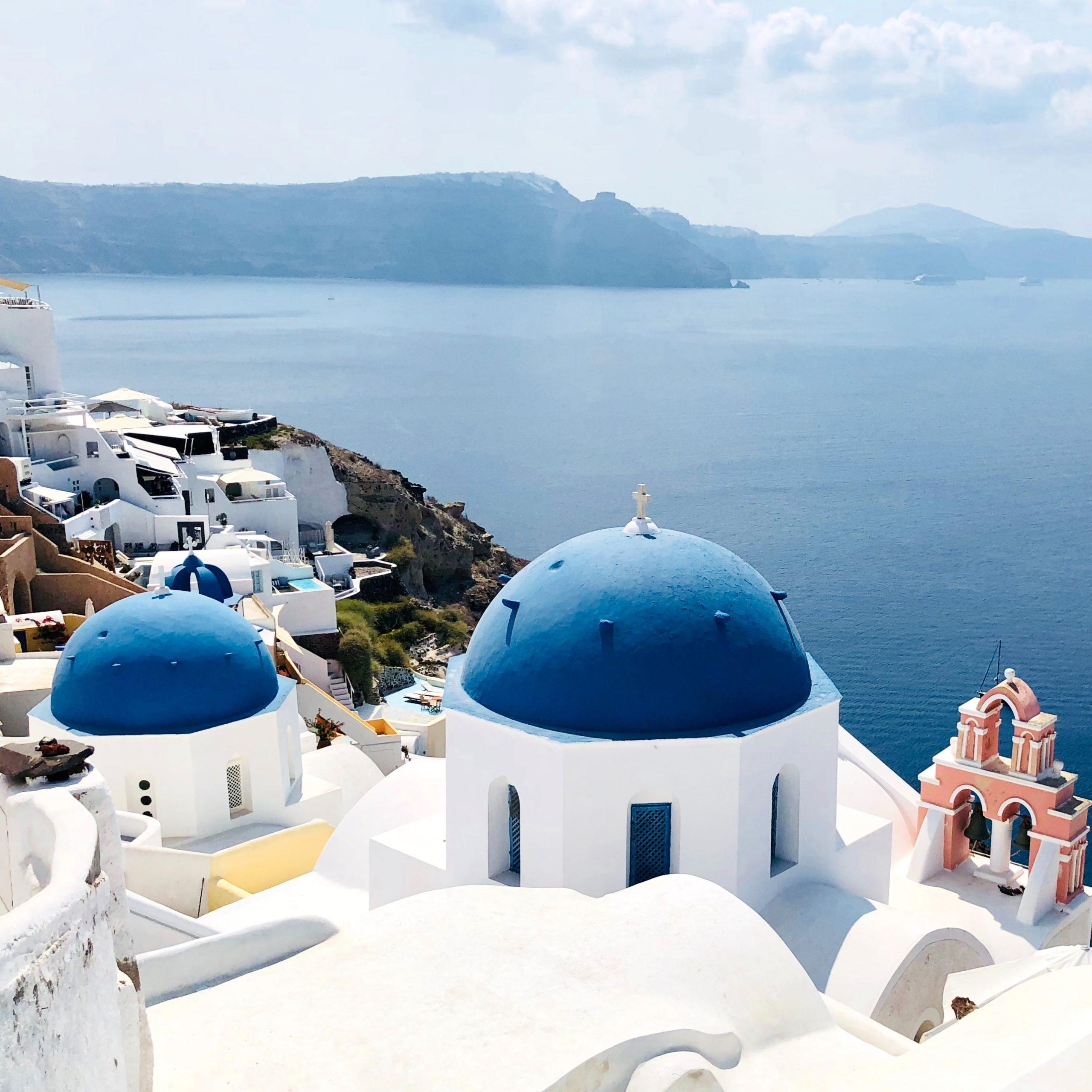 white dome buildings along the greek cost